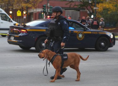 NYPD emergency service unit police officer with K-9 dog  at the crime scene near a terror attack site in lower Manhattan