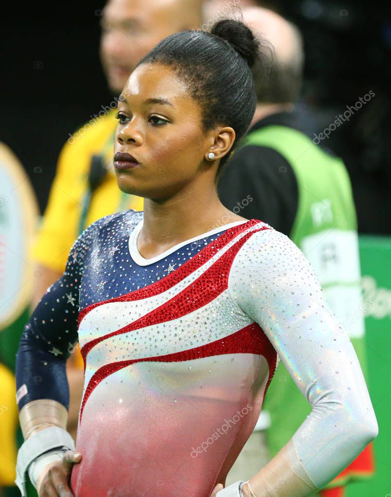 RIO DE JANEIRO, BRAZIL - AUGUST 9, 2016: Olympic champion Gabby Douglas of United States competing at team women's all-around gymnastics at Rio 2016 Olympic Games at Rio Olympic Arena