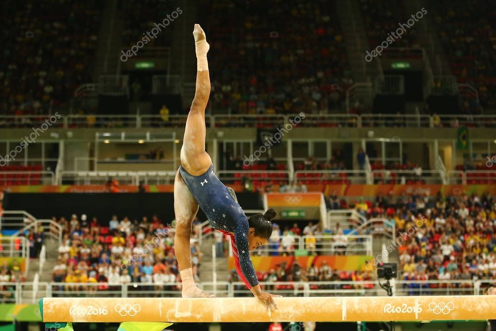 RIO DE JANEIRO, BRAZIL AUGUST 7, 2016: Olympic champion Gabby Douglas of United States competes on the balance beam at women's all-around gymnastics qualification at Rio 2016 Olympic Games