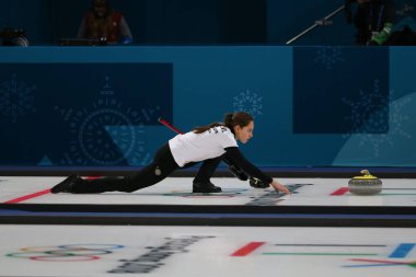 GANGNEUNG, SOUTH KOREA - FEBRUARY 10, 2018: Anastasia  Bryzgalova of Olympic Athlete from Russia competes in the Mixed Doubles Round Robin curling match at the 2018 Winter Olympics  clipart