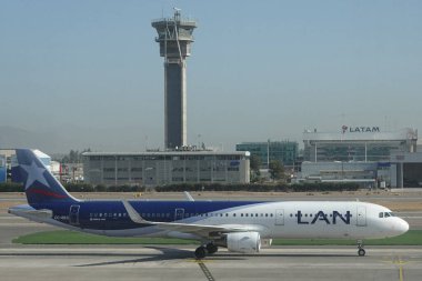 SANTIAGO, CHILE - JANUARY 30, 2020: Lan Airlines plane and Air Traffic Control Tower at Arturo Merino Benitez International Airport in Santiago, Chile clipart