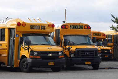 BROOKLYN, NEW YORK - MARCH 17, 2020: School buses parked on the yard in Brooklyn, NY after New York City closed down the public school system to stop the spread of the coronavirus (COVID-19)