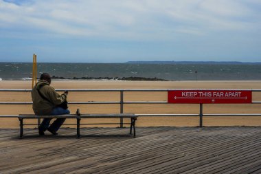BROOKLYN, NEW YORK - 20 Mayıs 2020: New York Şehir Parkları Departmanı tarafından imzalanan imza, Coney Island Sahili Riegelmann kaldırımında sosyal mesafenin 1.80 metre olduğunu gösteriyor.