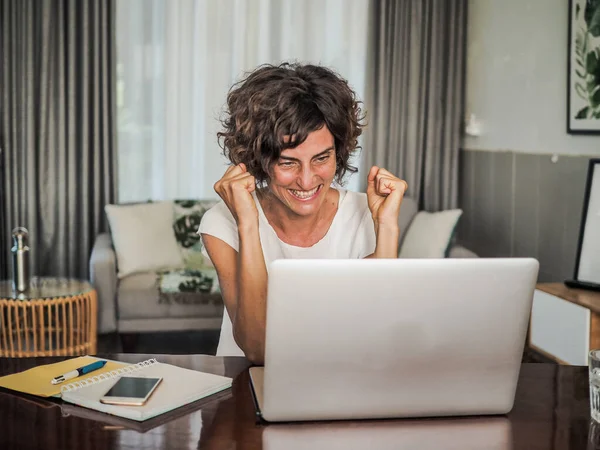 excited remote online working woman with laptop, work from home concept