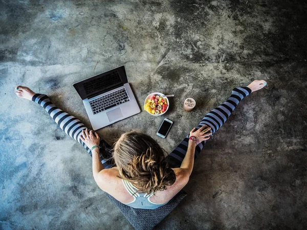 Ung Kvinna Äter Frukt Tittar Laptop Ovanifrån — Stockfoto