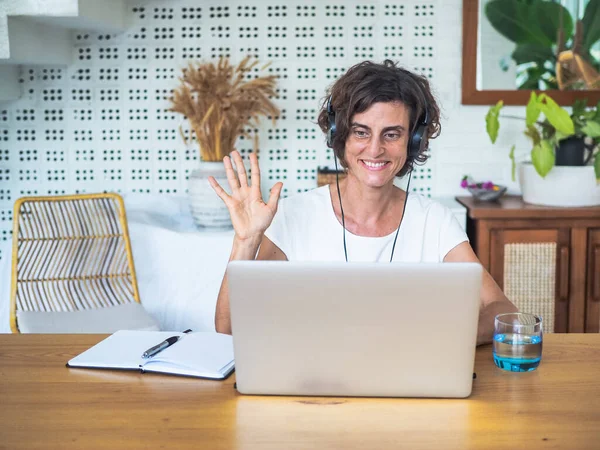 woman with laptop working in bedroom, home office and quarantine concept