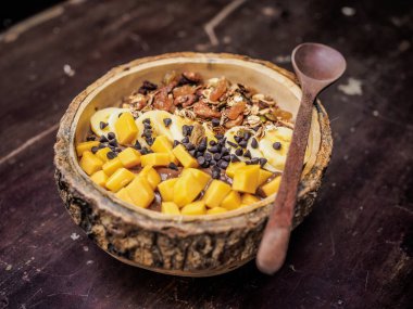 muesli with fresh banana and nuts in a bowl. toning. selective focus