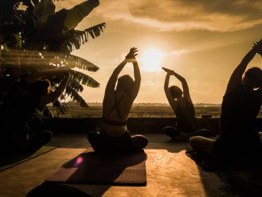 Ubud, Bali, Endonezya - 24 Mayıs 2020: insanlarla gün batımında tropikal açık yoga stüdyosu