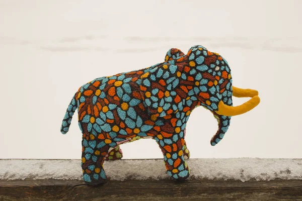 Decorative sculpture of an elephant. A toy made of Papier-mache. Motley beast.