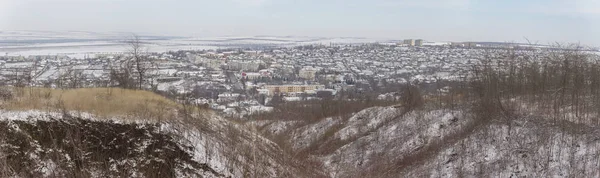 Winter landscape with snow. A frozen forest. The outskirts of the city, in March. The Bugeac steppe in the spring. The terrain in southern Europe.