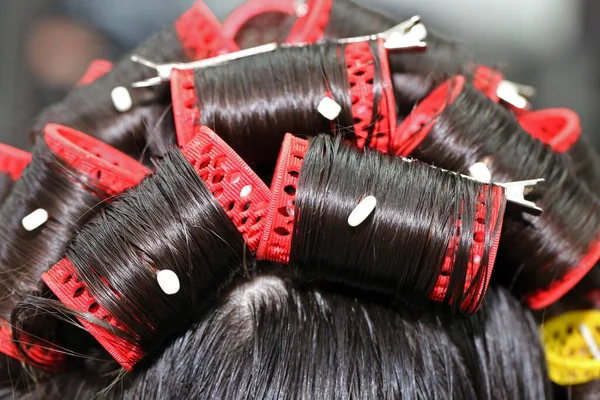 red curler on black hair