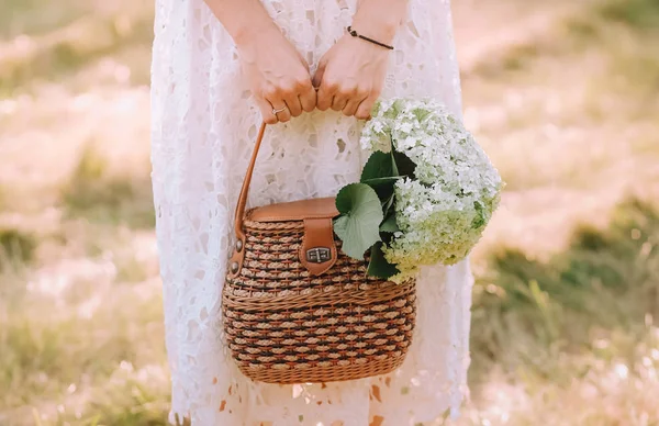 girl dress bag hold flowers bouquet white