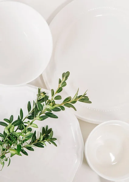 Zestaw biały dania talerze szklanki zdobione eukaliptusa — Zdjęcie stockowe