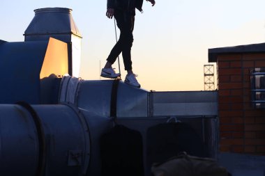 adam beyaz spor ayakkabı günbatımı bina çatı aşağı çalışır