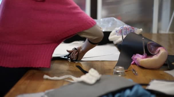 Seamstress woman cuts blanks patterns curly workshop — Stock Video