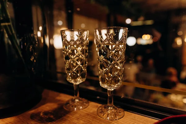 Two crystal glasses festive champagne blur light — 스톡 사진