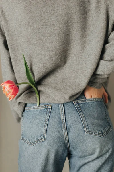 Girl Lifestyle Holiday Flower Tulip Jeans Pocket Backside Sweater Stock Photo