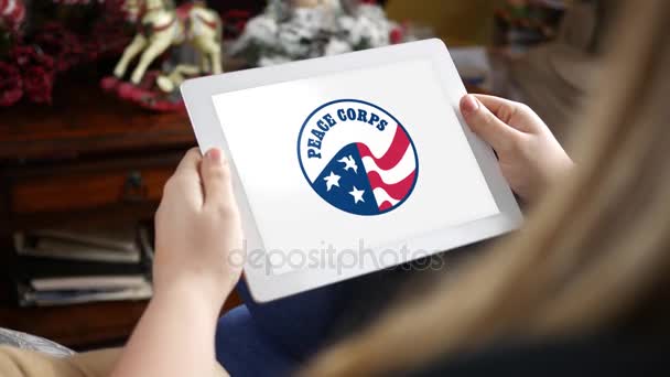 Circa January 2018 Woman Looking Peace Corps Logo Her Tablet — стоковое видео