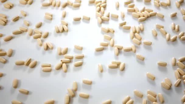 Spinning Vitamin Pills White Studio Background Angle — Stock Video