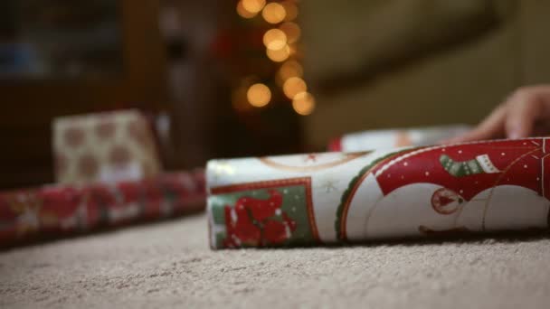 Close Red Mistletoe Wrapping Paper Bokeh Tree Background — Stock Video