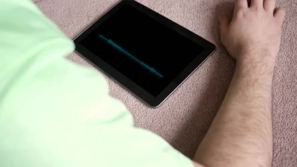 一个人听一个通用的假应用程序播放列表在他的 Tablet 数字波形版本 — 图库视频影像