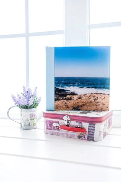 White photo book with leather and wood cover. stylish wedding photo album. Family photoalbum on the table.