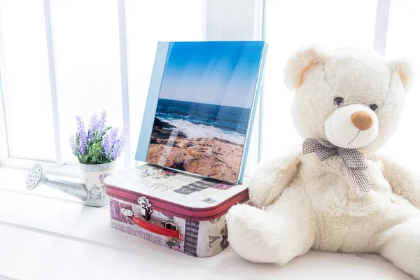 White photo book with leather and wood cover. stylish wedding photo album. Family photoalbum on the table.