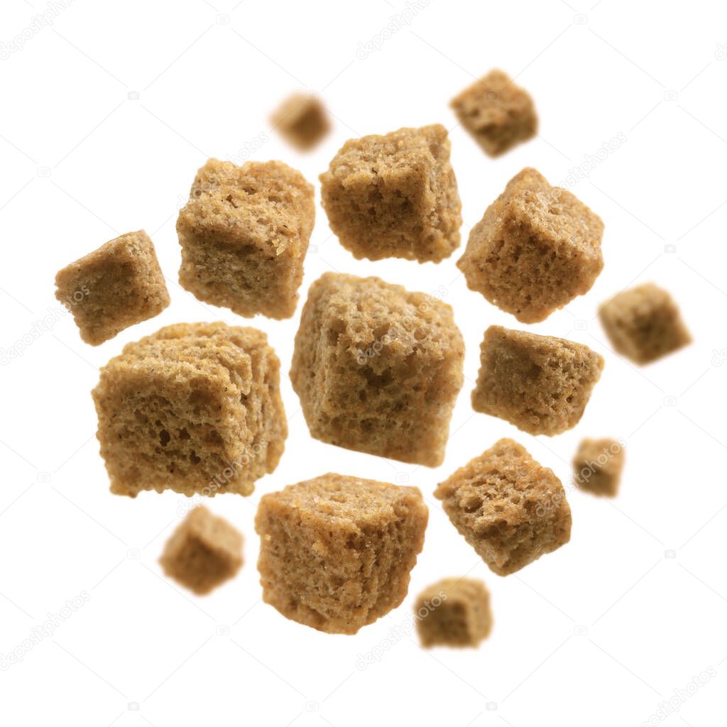 Bread croutons levitate on a white background