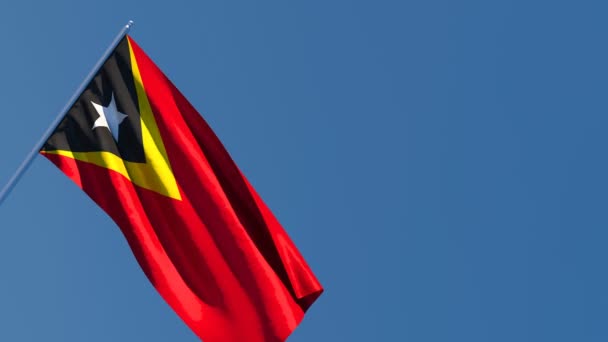La bandera nacional de Timor Oriental ondea en el viento — Vídeos de Stock
