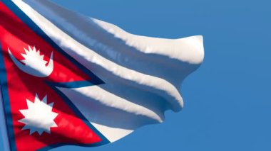 Nepal 'in ulusal bayrağı mavi gökyüzüne karşı rüzgarda dalgalanıyor.