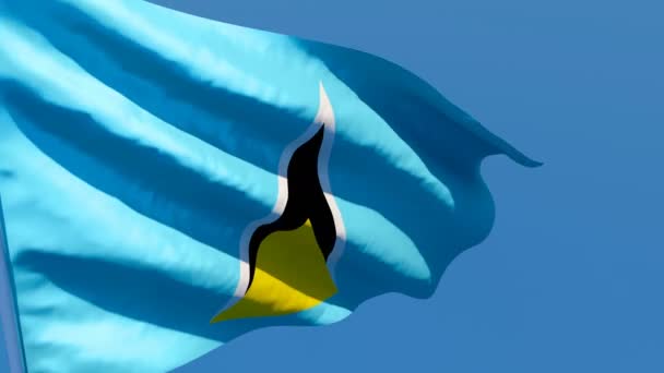 セントルシアの国旗が青い空に向かって風になびく — ストック動画