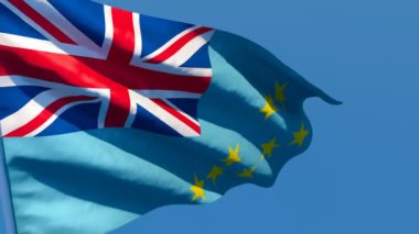 Tuvalu 'nun ulusal bayrağı mavi gökyüzüne karşı rüzgarda dalgalanıyor.