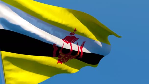 Державний прапор Брунею пурхає вітром проти блакитного неба. — стокове відео