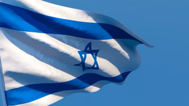 Le drapeau national d'Israël flotte dans le vent contre un ciel bleu 