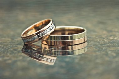 Two gold wedding rings of white and yellow gold clipart