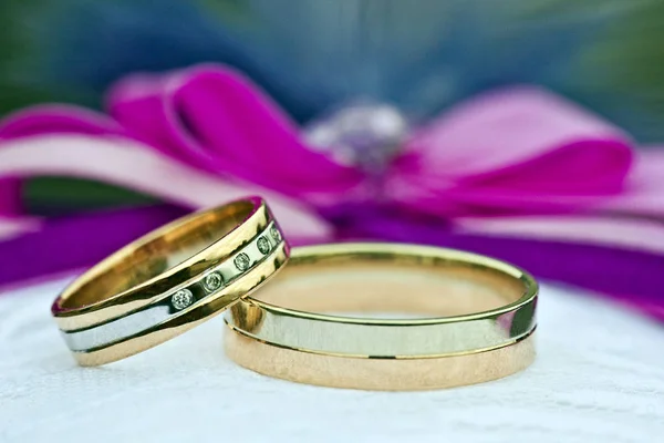 Two gold wedding rings of white and yellow gold
