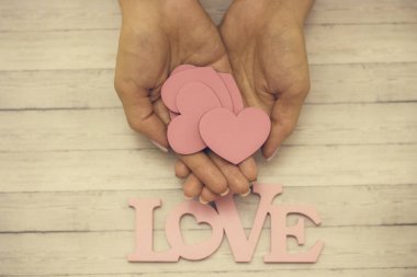 Bir el ahşap bir kalp, aşk kavramını tutar