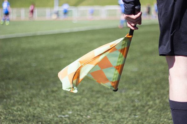 A football referee follows the game on the football field