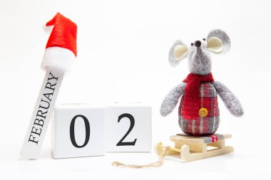 Wooden calendar with number February 2. Happy New Year! Symbol of New Year 2020 - white or metal (silver) rat. Christmas decorated.