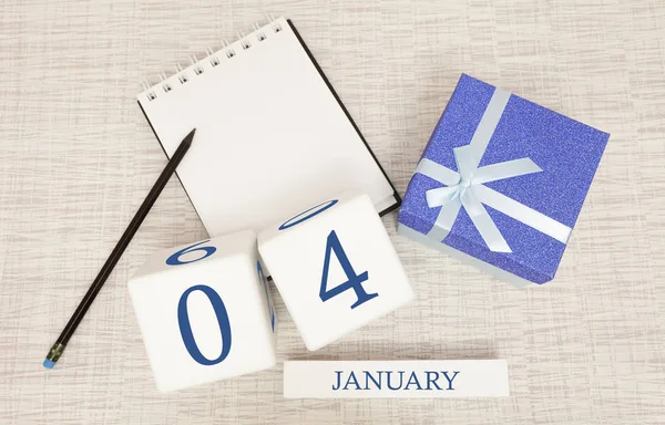 Calendar with trendy blue text and numbers for January 4 and a gift in a box. — Stock Photo, Image