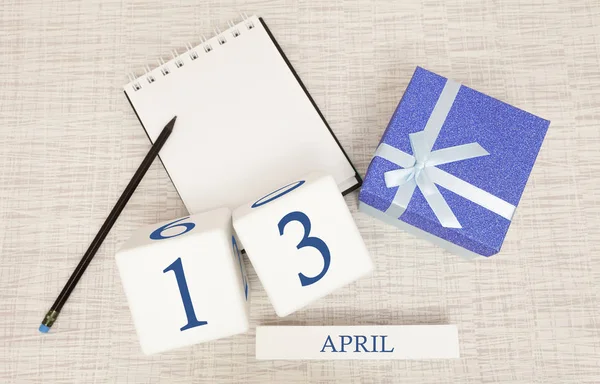 Calendar with trendy blue text and numbers for April 13 and a gift in a box. — Stock Photo, Image