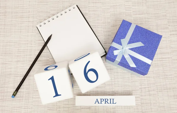 Calendar with trendy blue text and numbers for April 16 and a gift in a box. — Stock Photo, Image