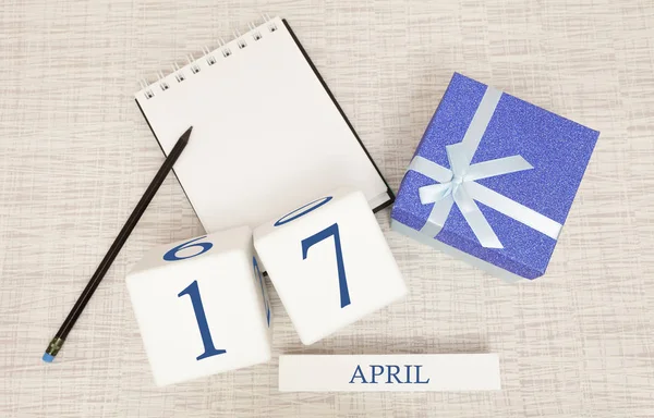 Calendar with trendy blue text and numbers for April 17 and a gift in a box. — Stock Photo, Image