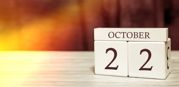 Kalender herinnering event concept. Houten blokjes met nummers en maand op 22 oktober met zonlicht. — Stockfoto