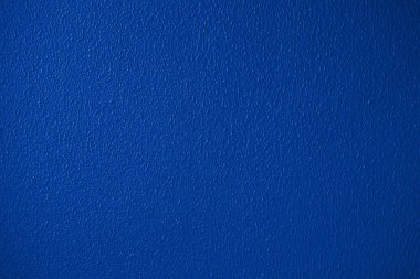 Blue or classic trendy color plaster wall texture detailed close-up