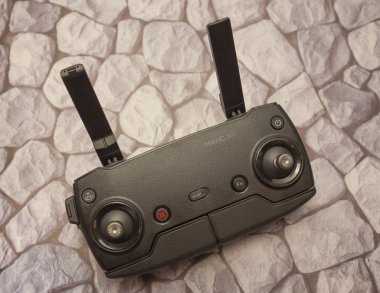 Remote control drone or copter on the background of stones