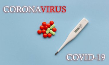 Coronavirus 2019-nCov virüs konsepti. Mavi arka planda hapları olan elektronik termometre.