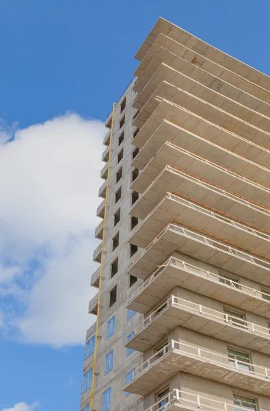 Concrete structure of a new multi-storey building (skyscraper) against the blue sky