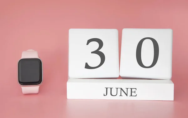 Modern Watch with cube calendar and date 30 june on pink background. Concept summer time vacation.