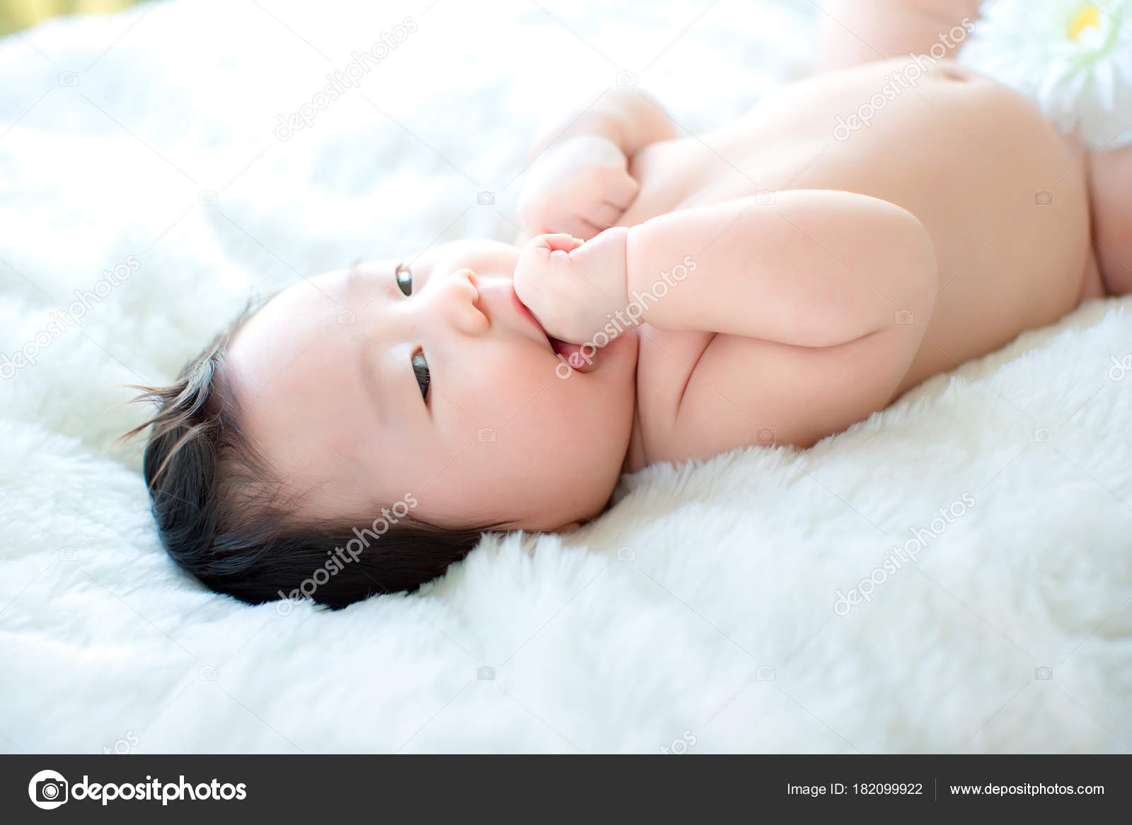 Newborn putting hands in cheap mouth
